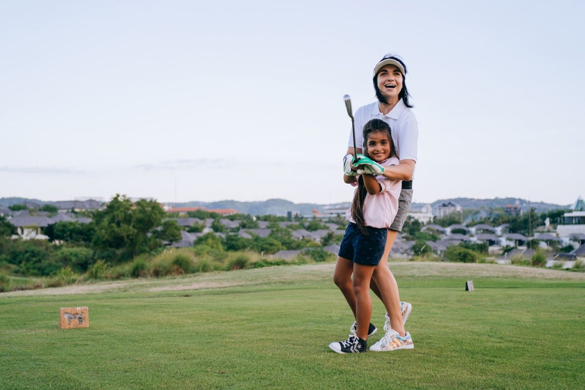A mother and daughter on the golf course